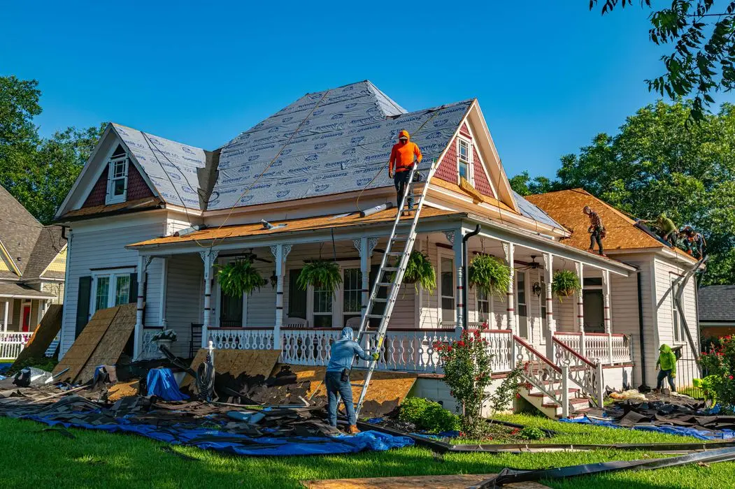 Oklahoma Exteriors crew replacing asphalt shingles on a residential roof