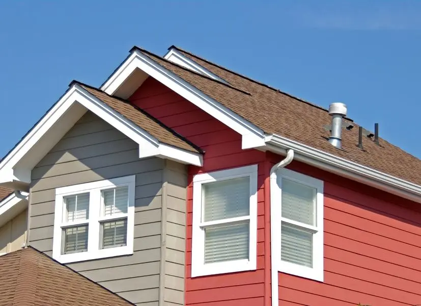 House exterior with newly installed siding, gutters and downspouts